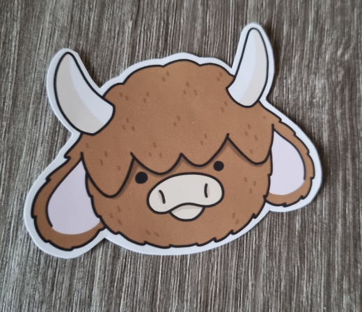 Cute brown fluffy longhorn cow, highland cow sticker